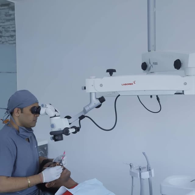 Dr. Rachit using LABOMED microscope for precision treatment